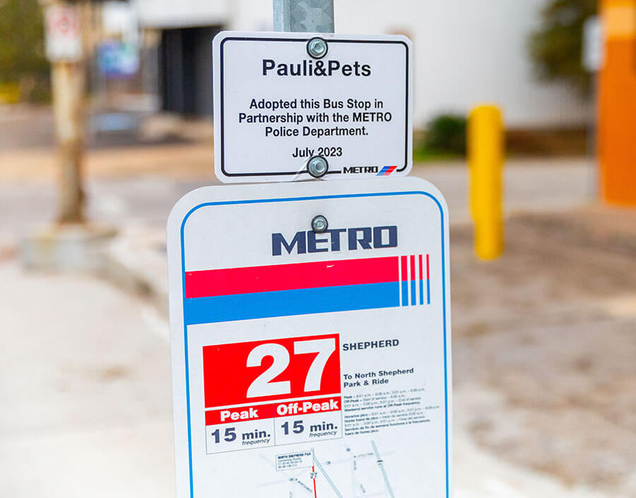 Adopt-a-Stop signage on a METRO bus stop pole